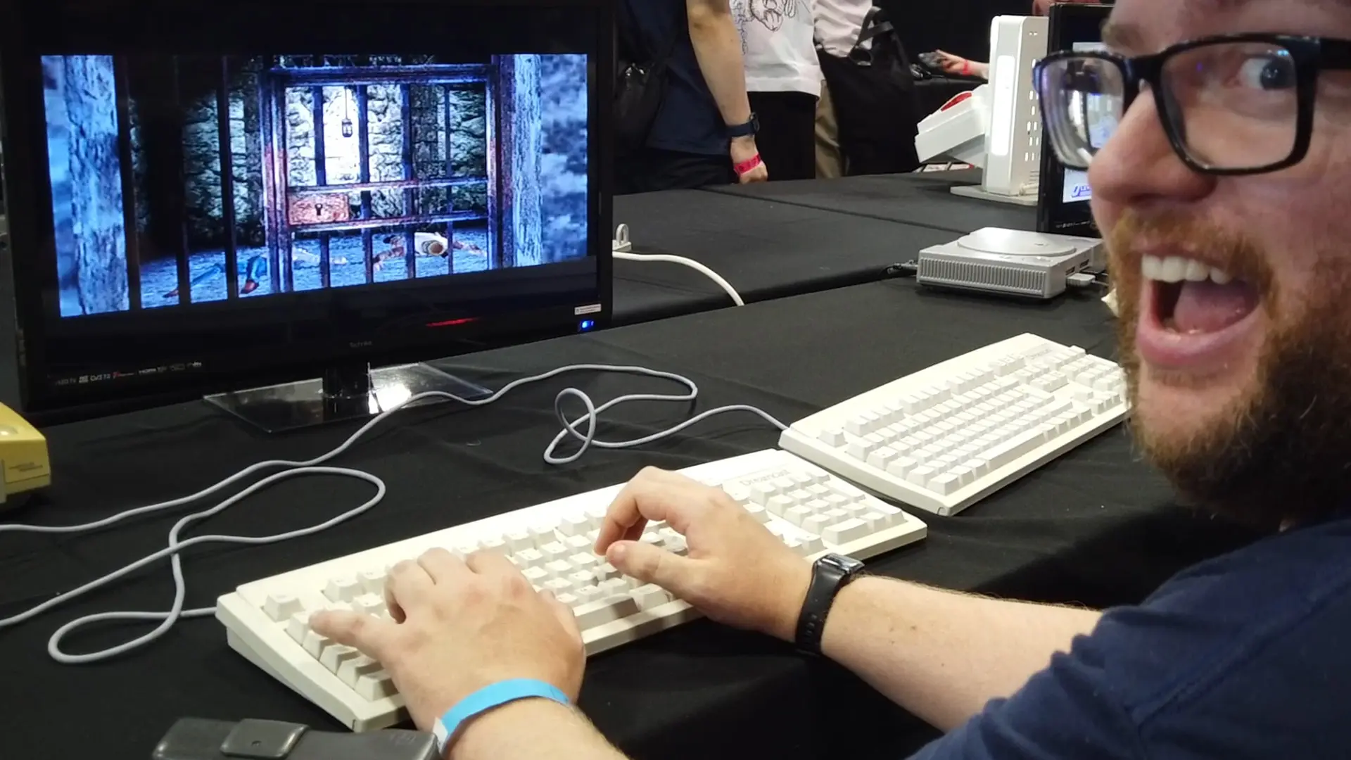 A photo of me looking happy as I play Typing Of The Dead