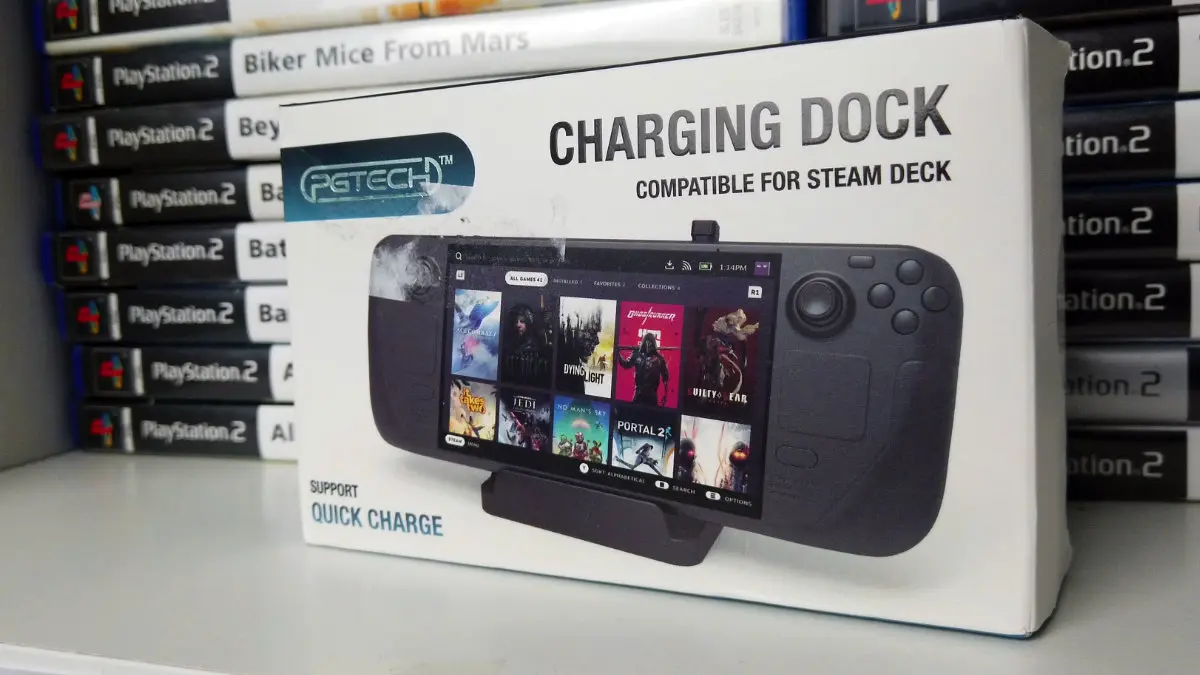 A photo of the PGTECH Charging Dock on a shelf in front of a stack of PlayStation 2 games