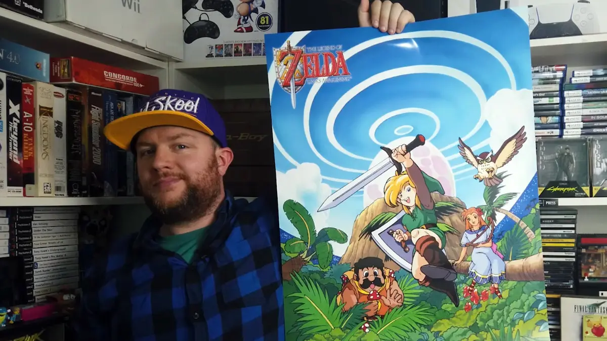 A image of me holding up a poster from The Legend of Zelda: Link's Awakening
